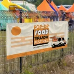 Closing Down Sale Banners: Printed food truck festival banner on a fence at an event