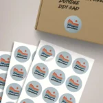 Stickers on a Sheet: Printed sticker sheets beside a mailing box